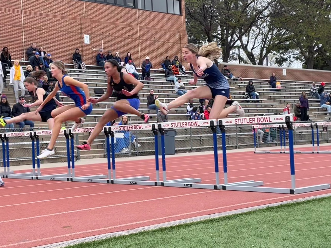 Girls jumping hurdles